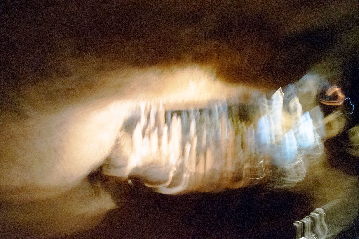 Abstract photo - white and blue crystalline structures surrounded by tan cave walls